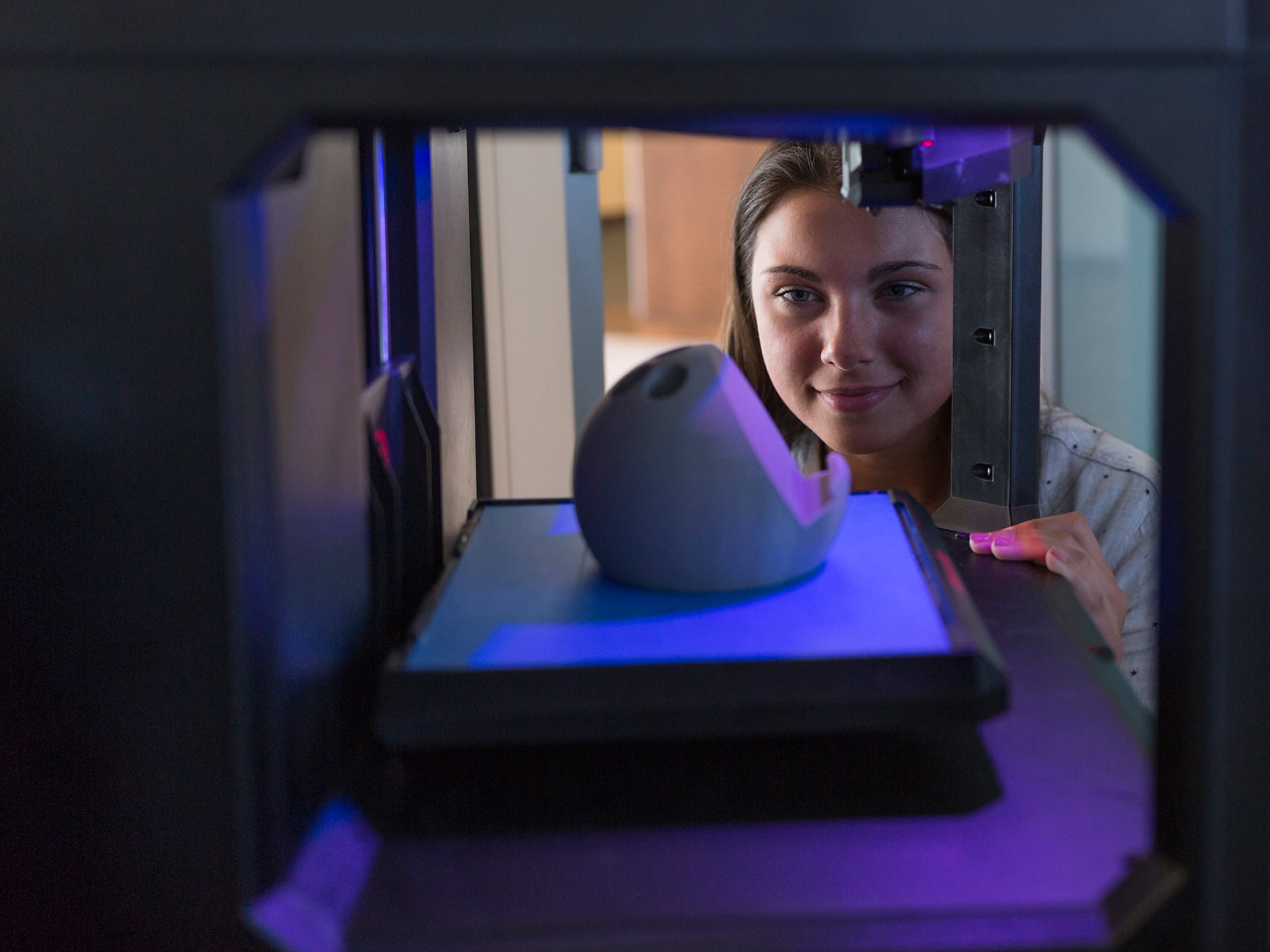 A girl looking in on an engineering experiment