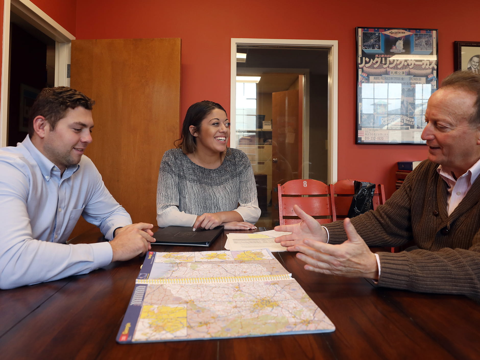 Students Mariana Pabon and Daniel Zabbo with their internship supervisor at The Gold Group. 