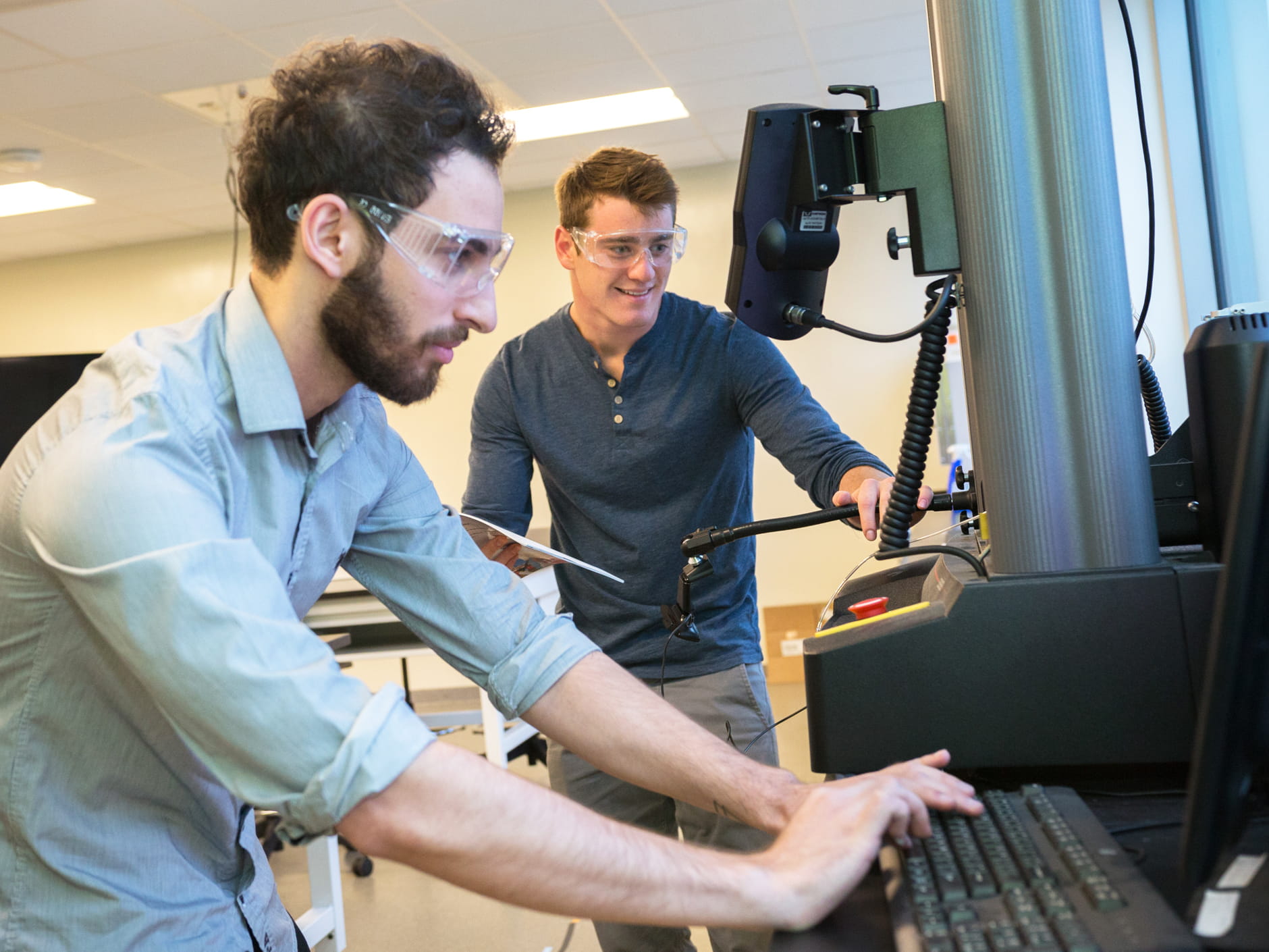Two men work at a computer