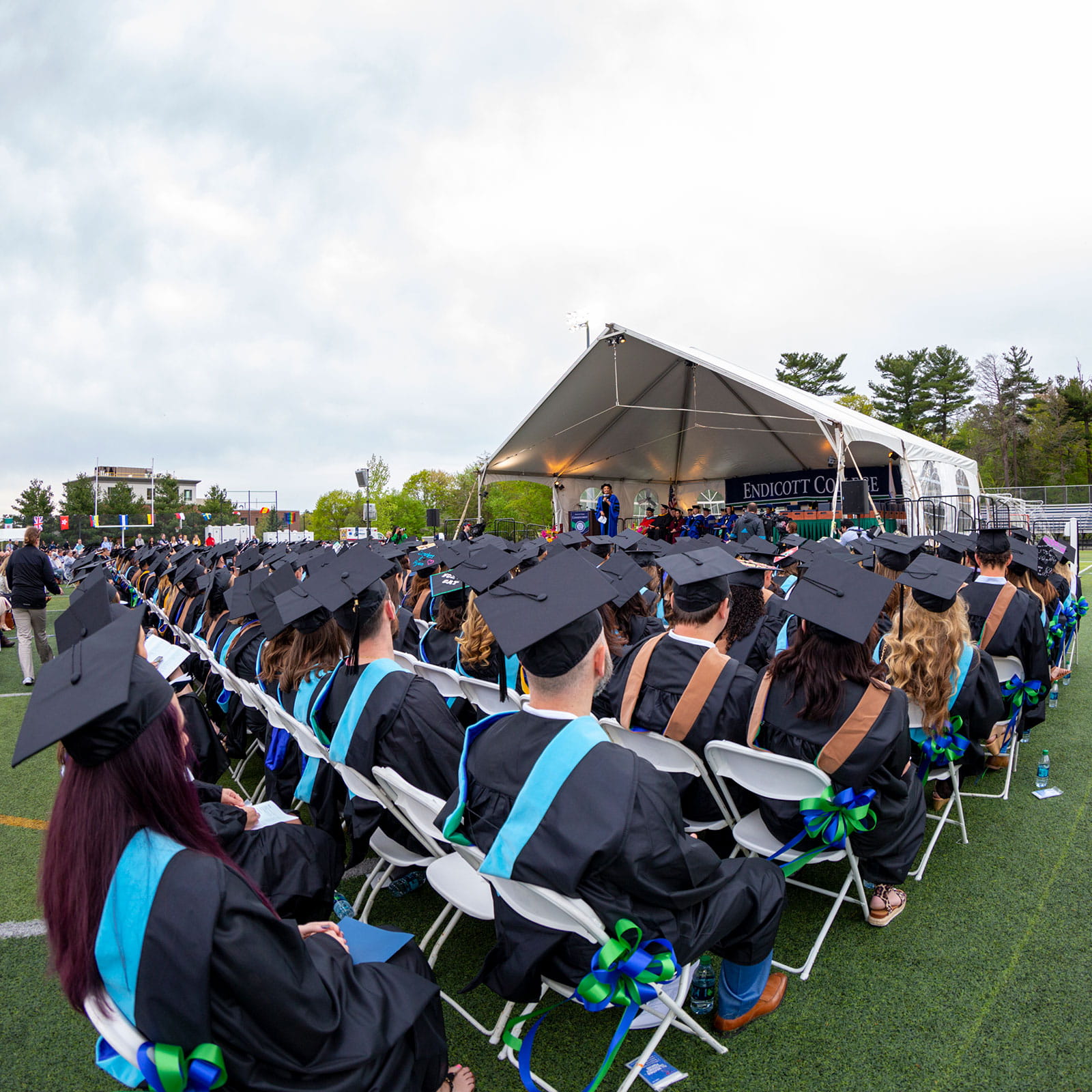 Crowd level view of graduates looking at the stage