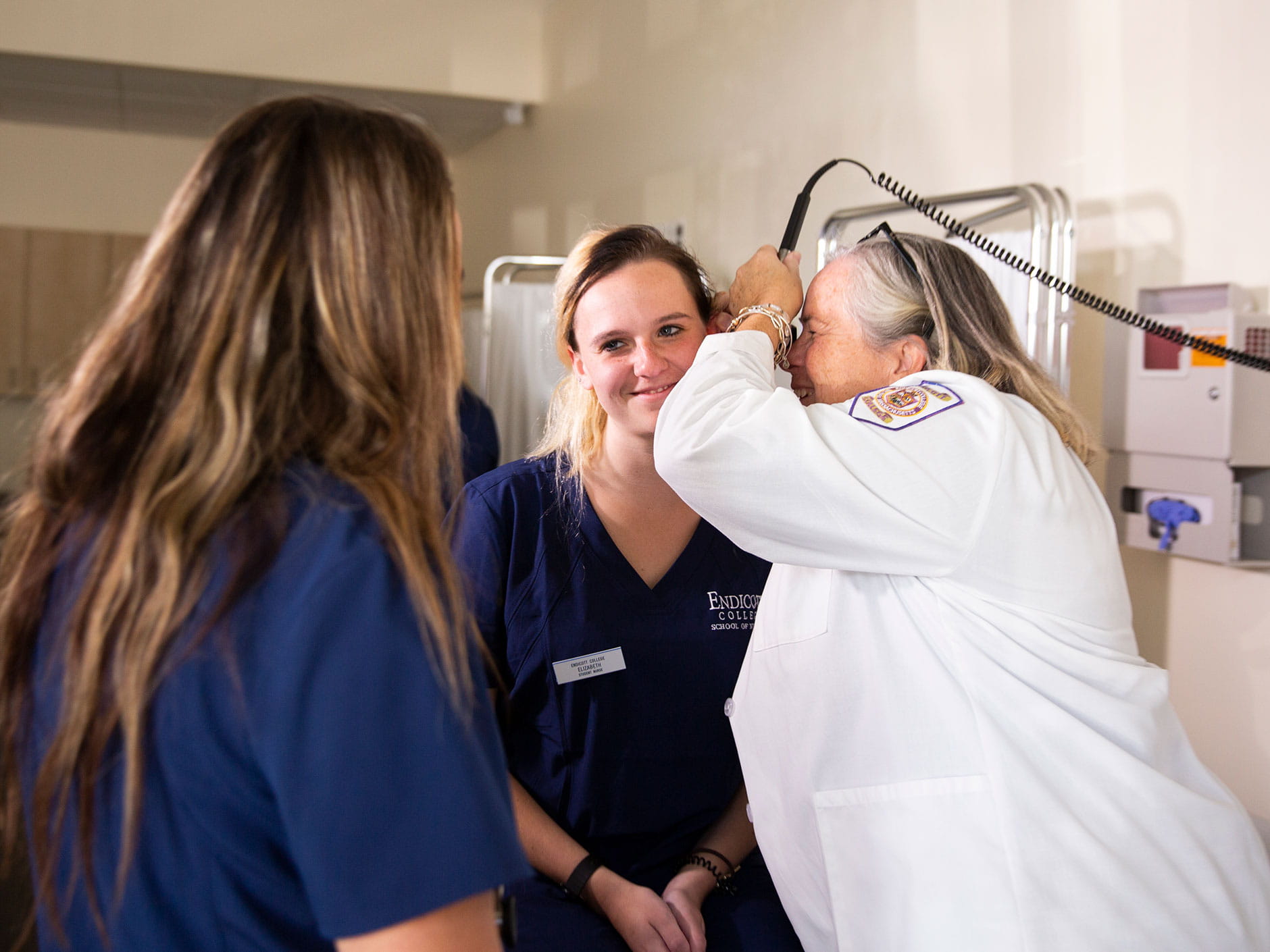 Faculty nurse examining a patient