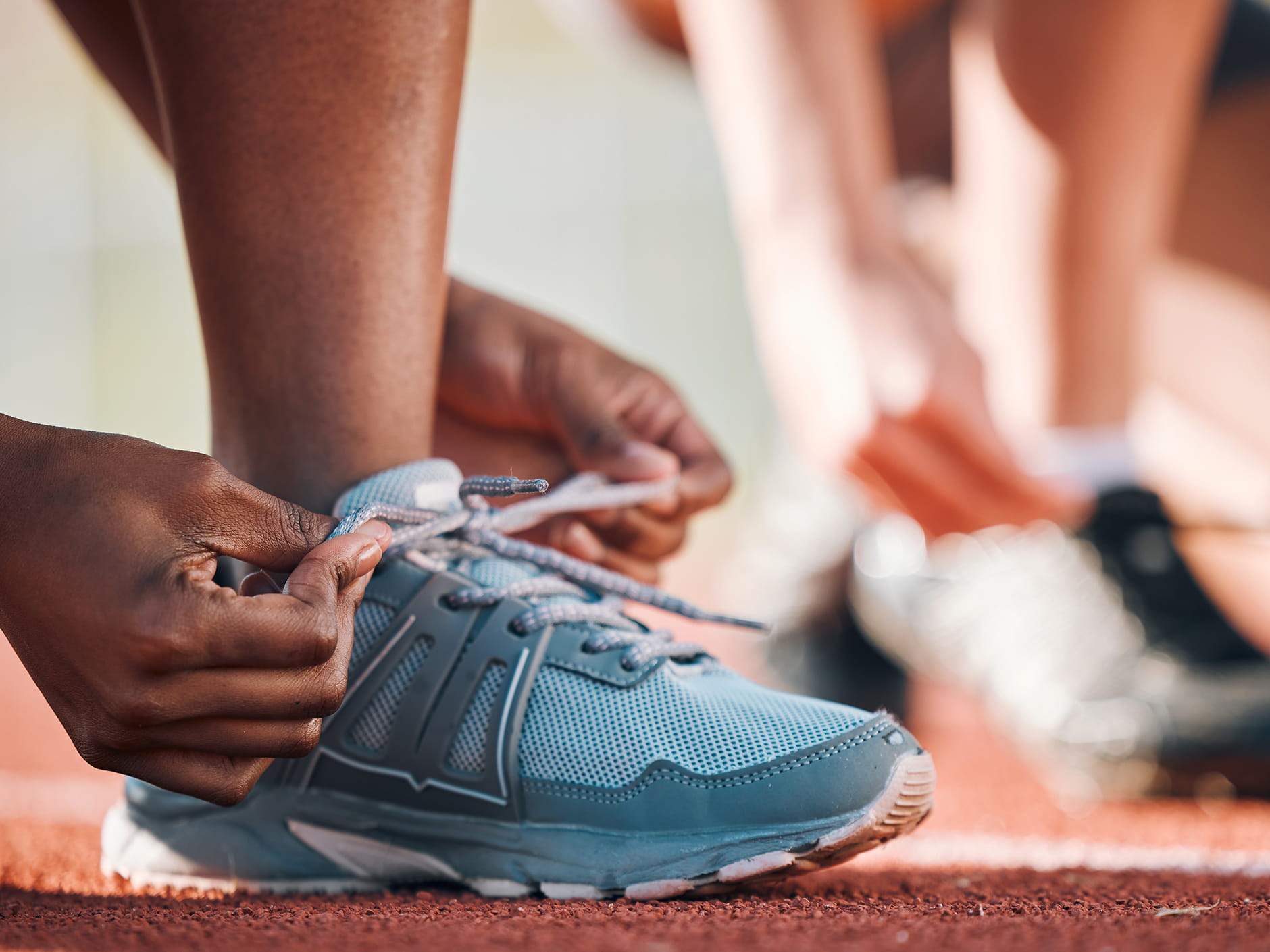 Hands tying laces of a sneaker