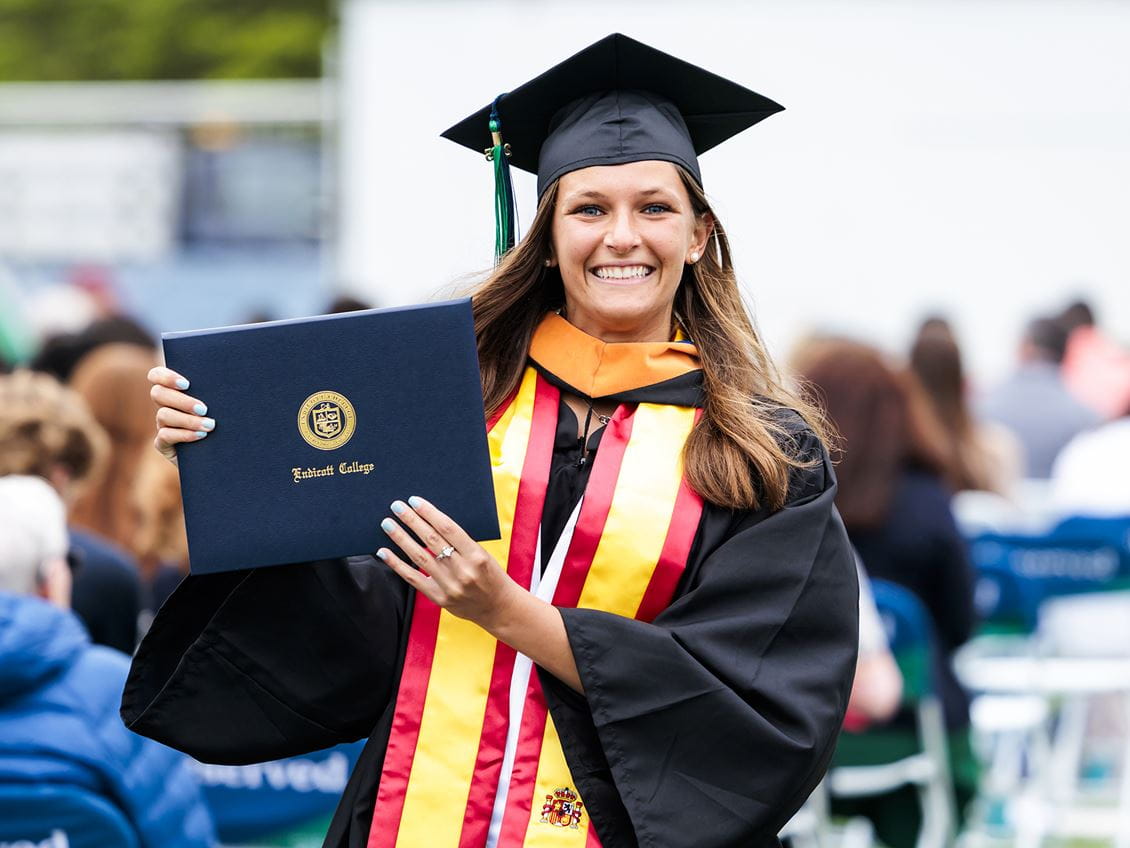 Student holding diploma at commencement