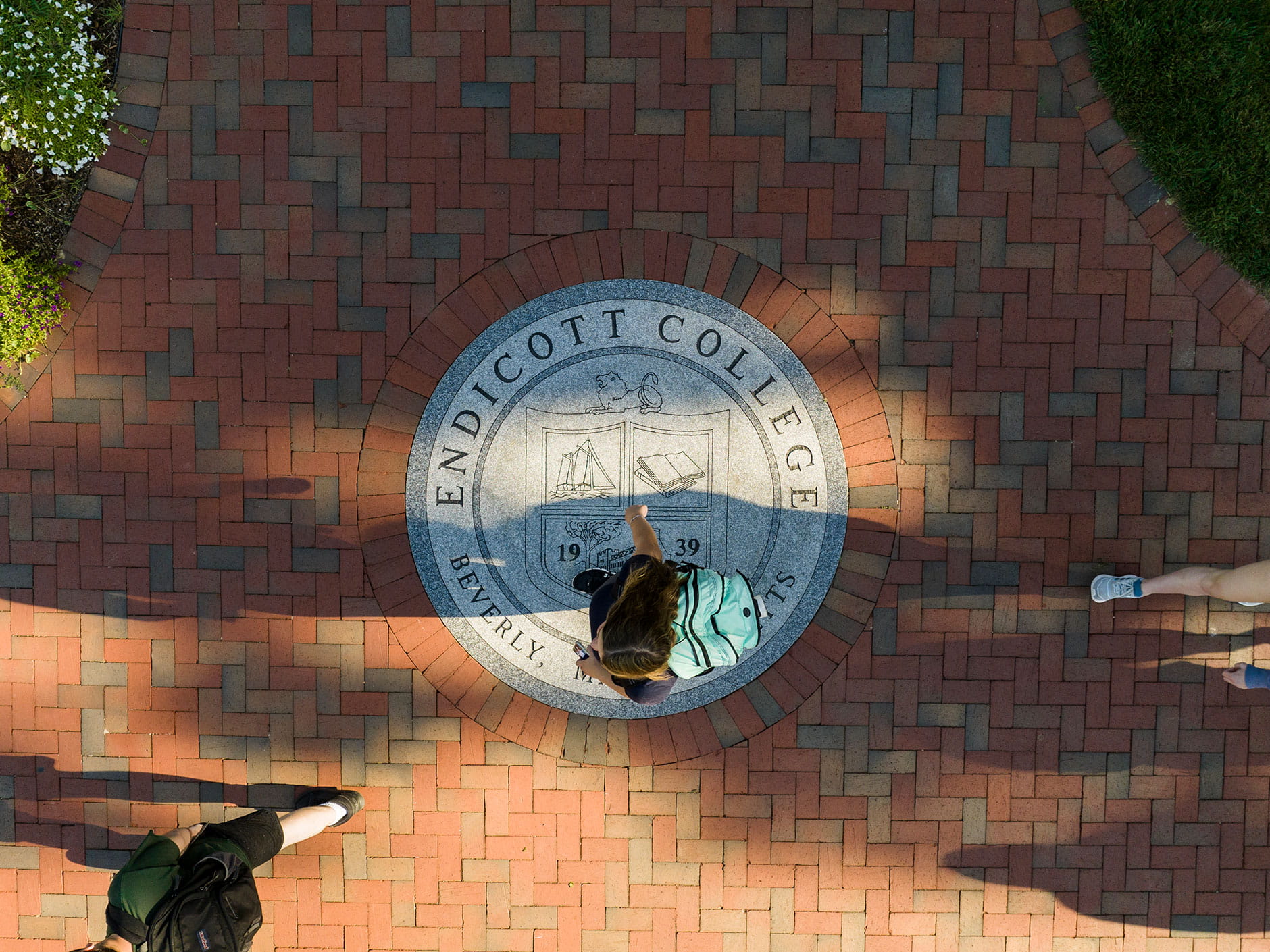 Students walking across a walkway at Endicott College
