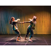 two girls pulling each other's arms