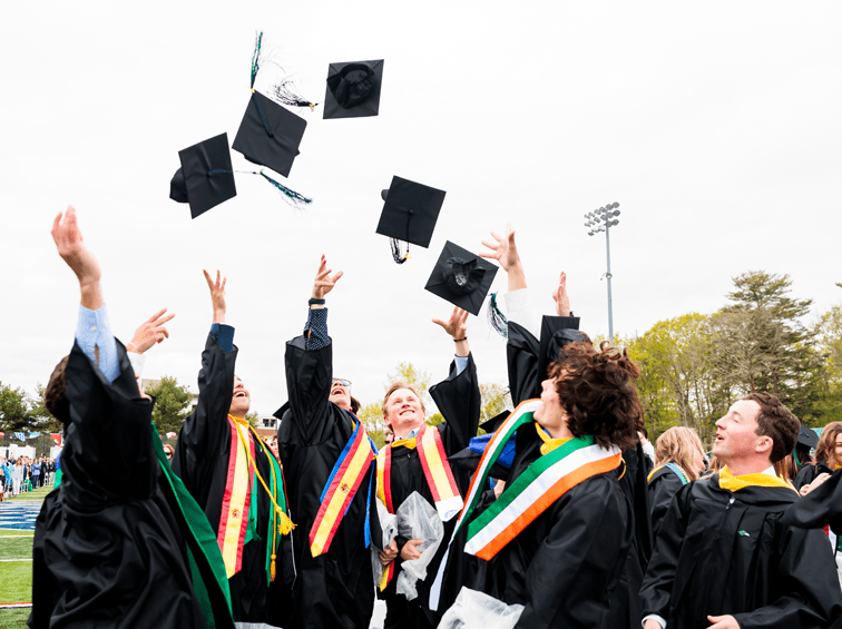 Students tossing caps into the air at commencement