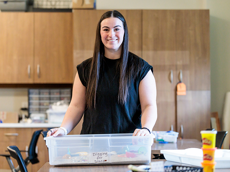 Endicott College student with teaching supplies in the classroom