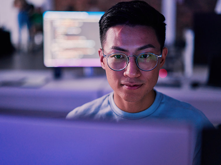 Person behind a computer screen