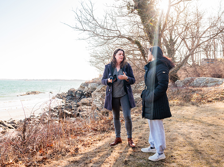 Students talking by the ocean