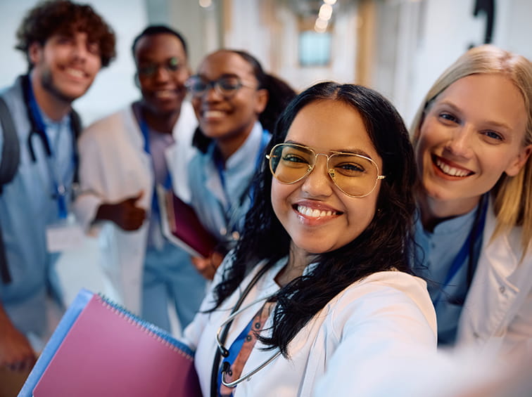 Students in scrubs and labcoats