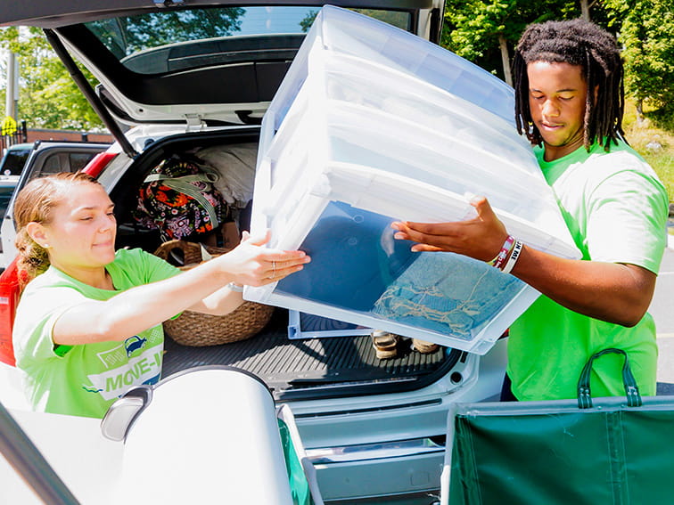 Students unpacking a car on move-in day