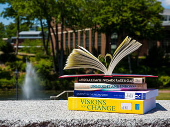A stack of book outside on Endicott's campus