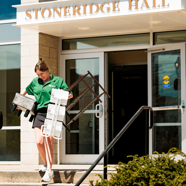 Student in from of Stoneridge Hall